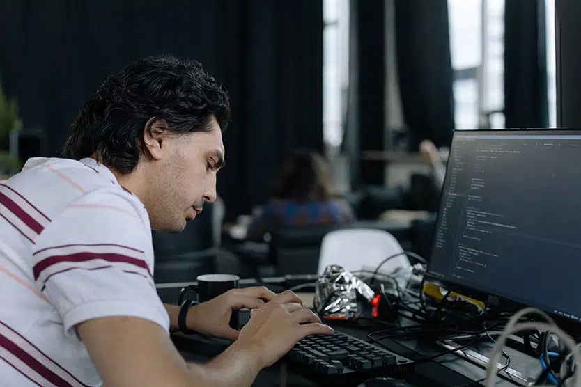 guy hard at work at a laptop, coding