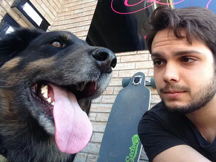 Eduardo soto and a dog with his large tongue hanging out