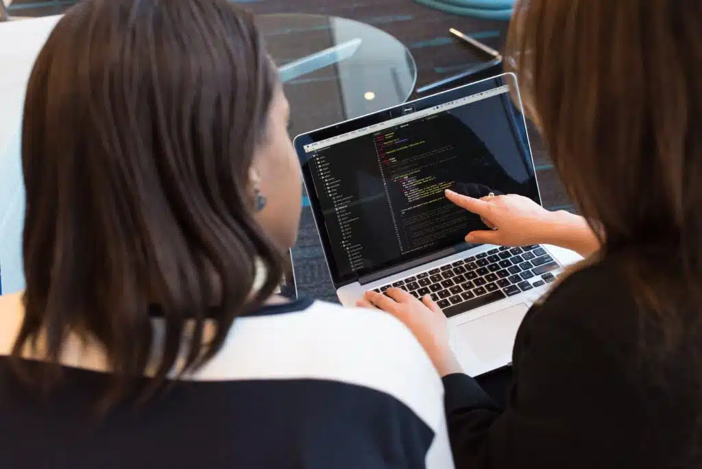 a teacher helping her student with coding