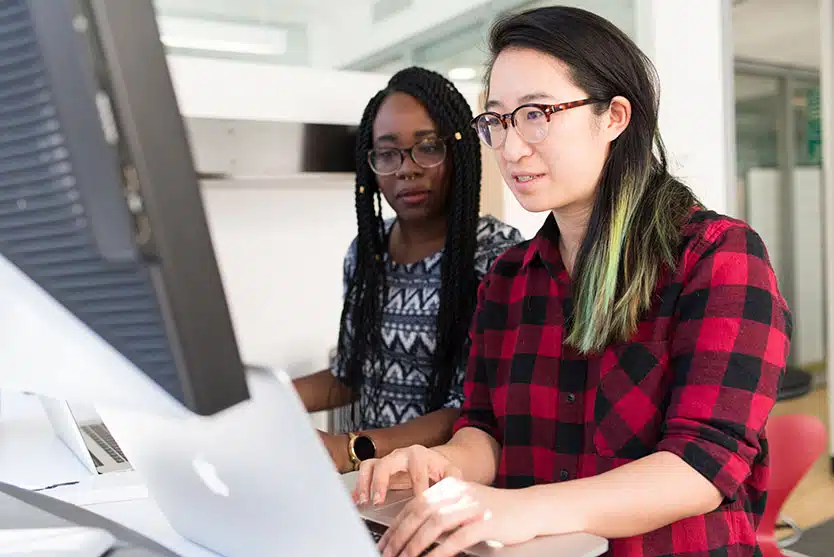 two women looking at a computer screen