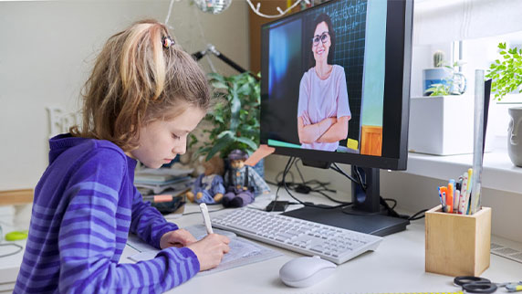 Girl learning math online using home computer