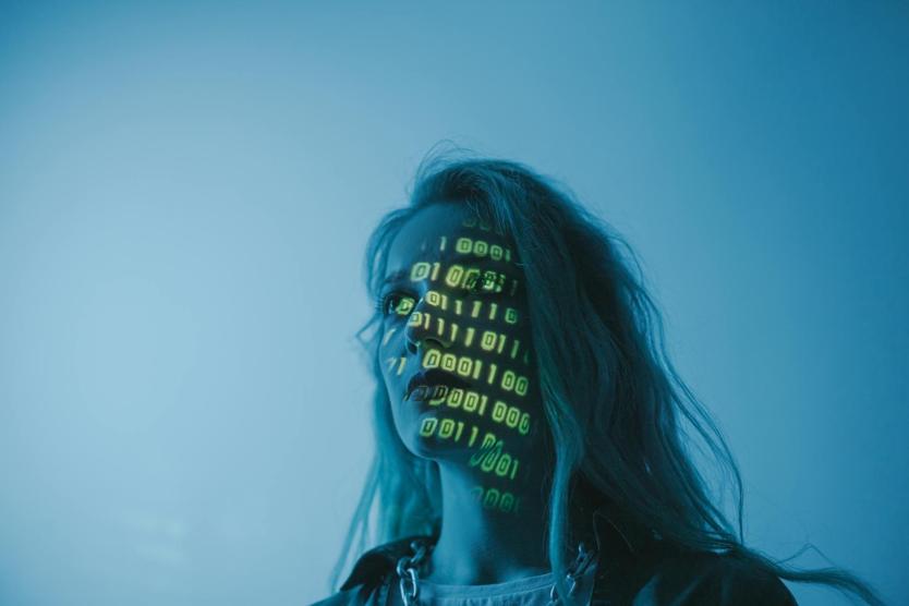 a woman with digital language projected on her face