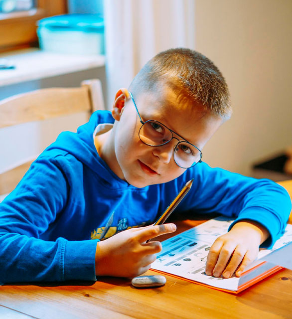 Side view of boy learning at home