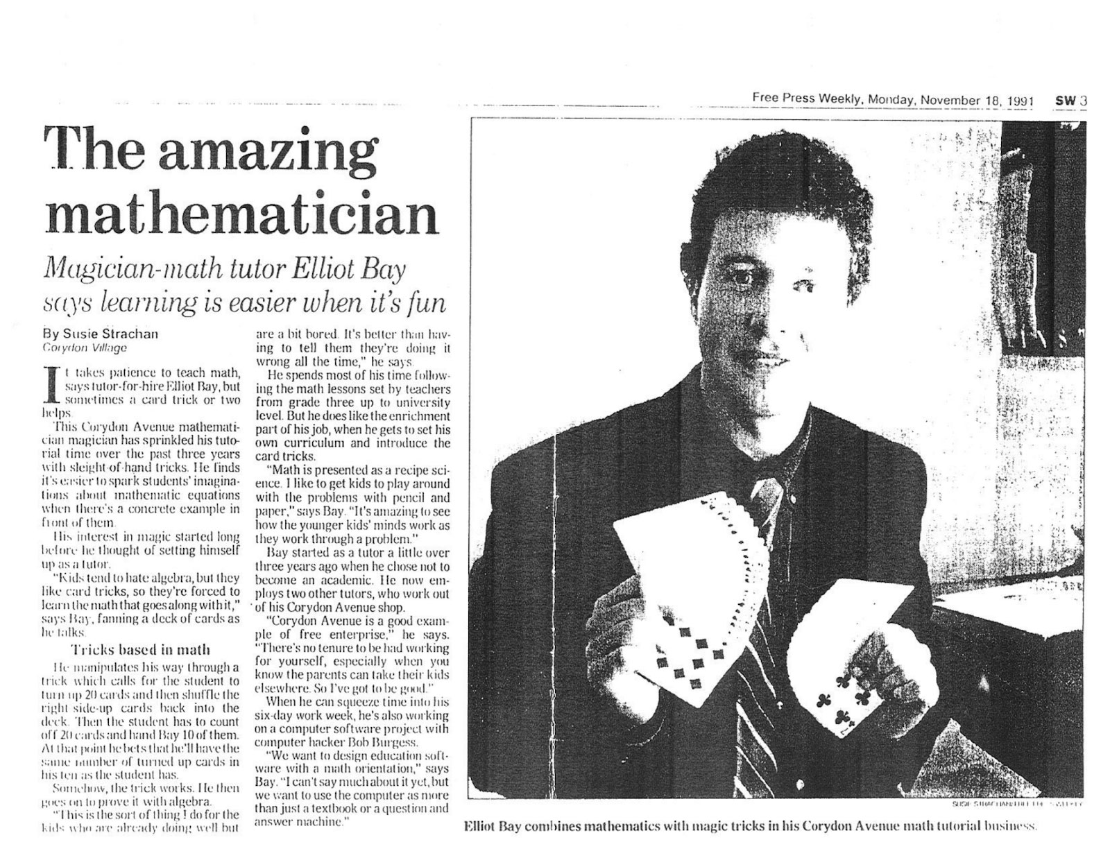 Newspaper article from November 18, 1991 with picture of Elliott Bay holding a deck of cards in each hand. To the side is the headline "The amazing mathematician" with subtitle "Magician-math tutor Elliot Bay says learning is easier when it's fun'.