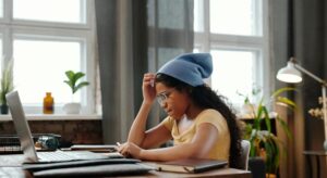 girl focusing on a laptop at a desk